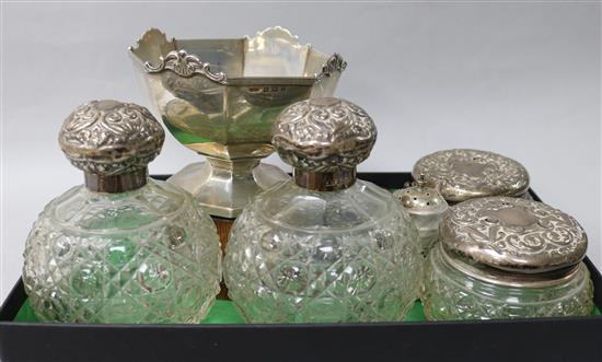 Two silver topped glass scent bottles, two other jars, a silver trophy bowl, spoon and three condiments.